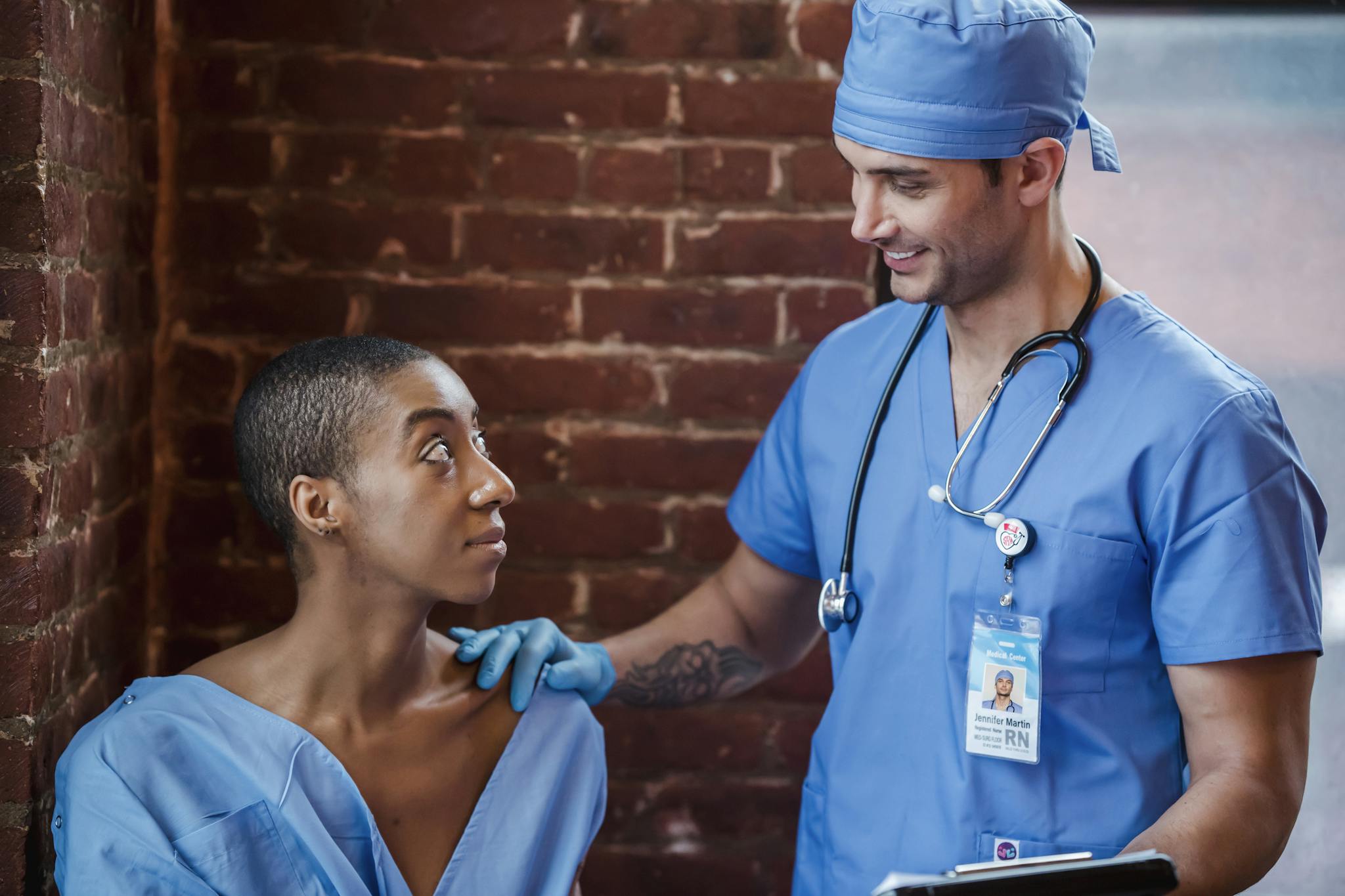 A medical professional consults a patient with a supportive and positive demeanor in a clinic setting.